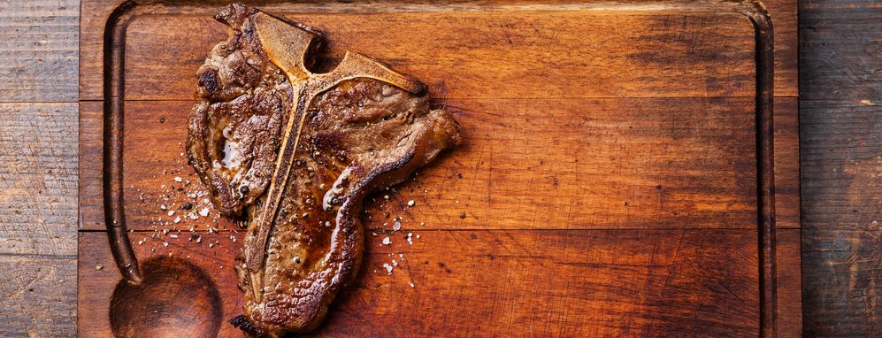 t bone steak on a wood e1582806218790