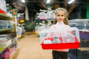girl with hamster cage